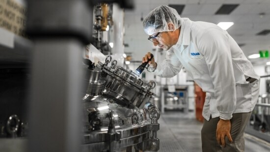 Ecolab serviceperson inspecting machine