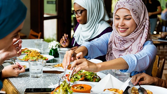 Group of women sharing a meal at clean table