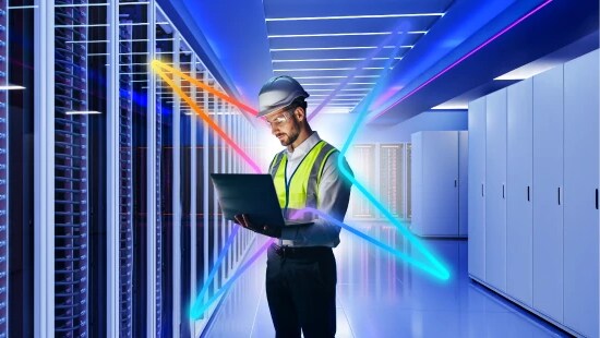 employee in PPE in data center aisle with an Ecolab spark overlay